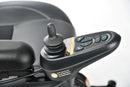 Close Up View Of The Merits Vision Sport Power Chair Control Joystick And Handlebar With Visible Buttons On A Blurred Background.