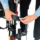 Removeable Battery Attachment Of The Feather Electric Wheelchair With Person Connecting The Charger