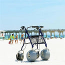 Front Right View Of The Debug Mobility All-Terrain Beach Rollator In A Beach Setting With The Ocean In The Background