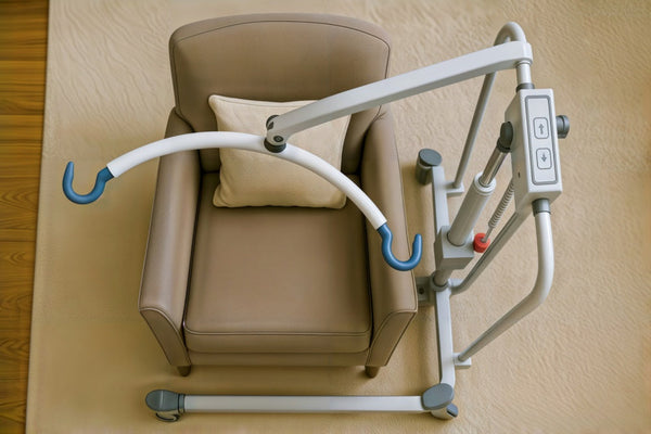 Hoyer lift over a brown armchair
