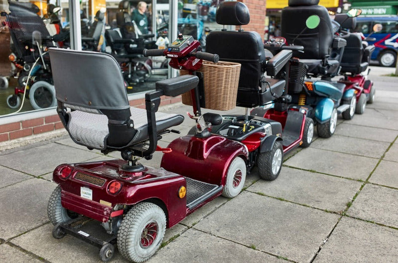 A line of red mobility scooters.