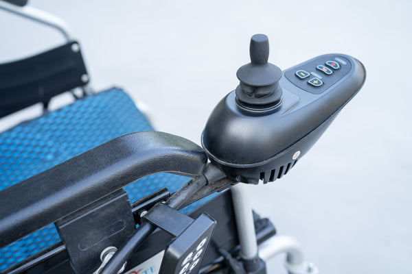 Close up image of an electric wheelchair's controls.