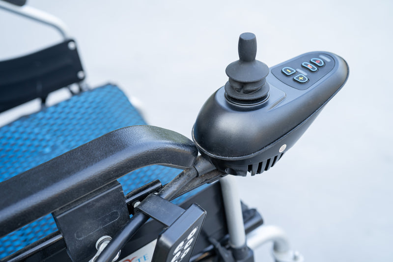 Close up image of an electric wheelchair's controls.