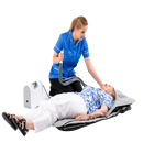 A Caregiver In A Blue Uniform Applies The Winncare Mangar Camel With Airflo 24 To An Elderly Woman