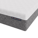 A Close-Up Studio Shot Of A The Corner Of The Luxury Dawn House Foam Mattress Showing A White Top Surface With A Subtle Sunburst Pattern And A Heather Gray Quilted Side, With A Visible Dawn House Label