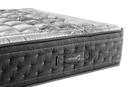 A Close-Up Studio Shot Of The Eurolux Multisens: The 11-Layer Luxury Mattress Crafted By Masters Mattress Corner Showing A Tufted Dark Gray Side Panel With A Visible 'Naturala' Label, And A Light Gray Quilted Top Surface With A Floral Pattern