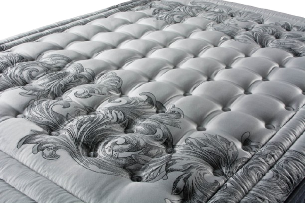 A Close Up View Of The Eurolux Multisens: The 11-Layer Luxury Mattress Crafted By Masters Highlighting Its Dark Gray Ornate Scroll Pattern