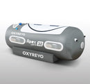 A gray OxyRevo Apex32 1.5 ATA Portable Hyperbaric Chamber with multiple windows and branding on the side.