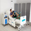 A Man Using The Kinetec Spectra Essential Knee CPM Machine Which Is Used For Knee Rehabilitation On A Hospital Bed.