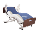 A Medical Bed With The Joerns PrevaMatt® Console Mattress Series With White Metal Frame Side Rails And Brown Wooden Head And Footboards