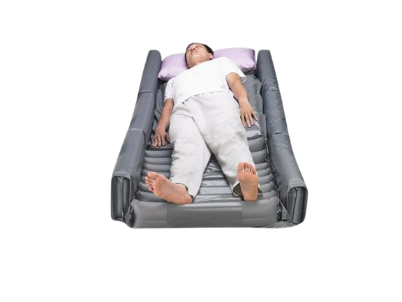 A Person Lying On Wellell Optima Turn Lateral Rotation Pressure Relief Mattress With Stretch Cover And A Light Purple Pillow Shown In The Left Rotation Position