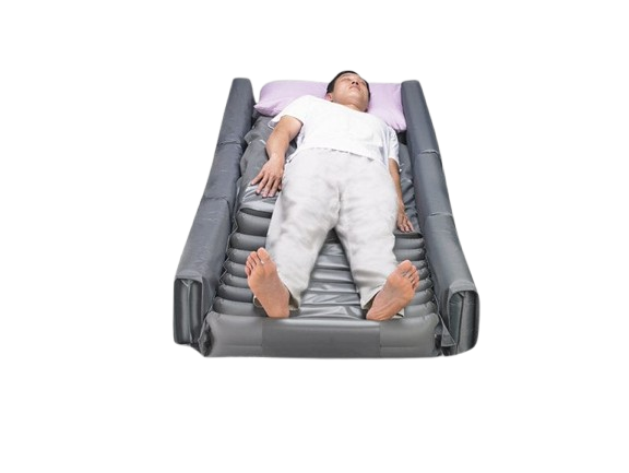 A Person Lying On Wellell Optima Turn Lateral Rotation Pressure Relief Mattress With Stretch Cover And A Light Purple Pillow Shown In The Right Rotation Position