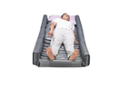 A Person Lying On Wellell Optima Turn Lateral Rotation Pressure Relief Mattress With Stretch Cover And A Light Purple Pillow Shown In The Right Rotation Position