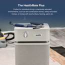 A Sandstone Austin Air Systems HealthMate Plus Standard Air Purifier Shown In A Workshop Setting With Tools Resting On Top, Accompanied By Promotional Text At The Top About The HealthMate Plus