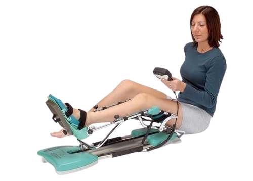 A Woman Using A Kinetec Spectra Essential Knee CPM Machine, Which Is Designed For Knee Rehabilitation. 
