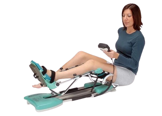 A Woman Using A Kinetec Spectra Essential Knee CPM Machine, Which Is Designed For Knee Rehabilitation. 