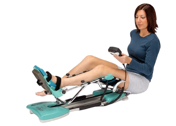An Attractive Woman Using A Kinetec Spectra Essential Knee CPM Machine Which Is Designed For Knee Rehabilitation 