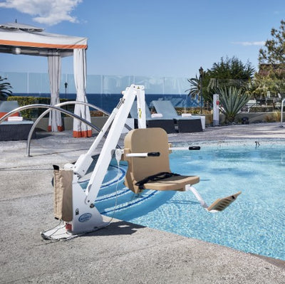 Aqua Creek Ranger 2 Pool Lift Chair By A Pool With Lounge Chairs And A Cabana In The Background.