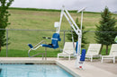 Aqua Creek Scout Excel Pool Lift Blue Color By A Pool With Lounge Chairs In The Background.