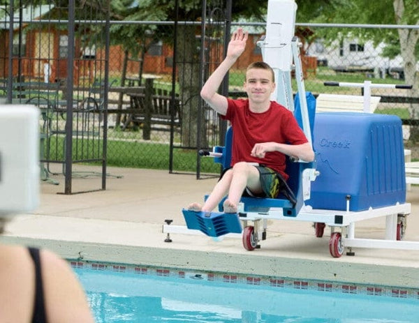Boy Using The Aqua Creek Voyager Pool Lift Blue Color Front View To Enter A Pool. 