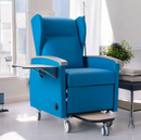 Close Up Centered View Of The Nitrocare Aura 911 Chemotherapy Recliner Chair Shown With Side Arm Table Extended As Well As Under Chair Footrest Shown In A Medical Setting
