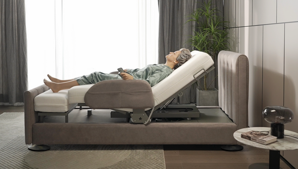 Close Up Left Side View Of The StarSleep Arlo Rotating Bed With An Elderly Woman Lying In The Bed In The Head Elevated Position Shown In A Bedroom Setting