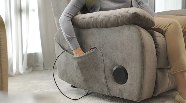 Close Up Right Side View Of The Lower Storage Pocket For The StarSleep Starise Massage Lift Chair Shown With A Human Hand Reaching Inside The Pocket