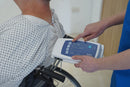 Close Up View Of A Healthcare Worker Using The Control Unit While The Patient Sits On The Wellell Sedens 500 Seat Cushion With Battery Power Shown In A Healthcare Setting