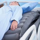 Close Up View Of A Patient Lying On The Wellell Optima Turn Lateral Rotation Pressure Relief Mattress With Stretch Cover Showing The Left Side Lateral Rotation In Motion