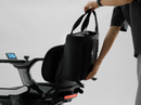 Close Up View Of A Person Attaching The STRUTT ev1 Smart Electric Mobility Vehicle Optional Rear Storage Bag Accessory To The Back Of The STRUTT ev1 Seat