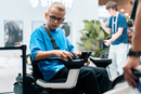 Close Up View Of A Young Boy In A Blue Shirt Operating The STRUTT ev1 Smart Electric Mobility Vehicle In An Indoor Setting