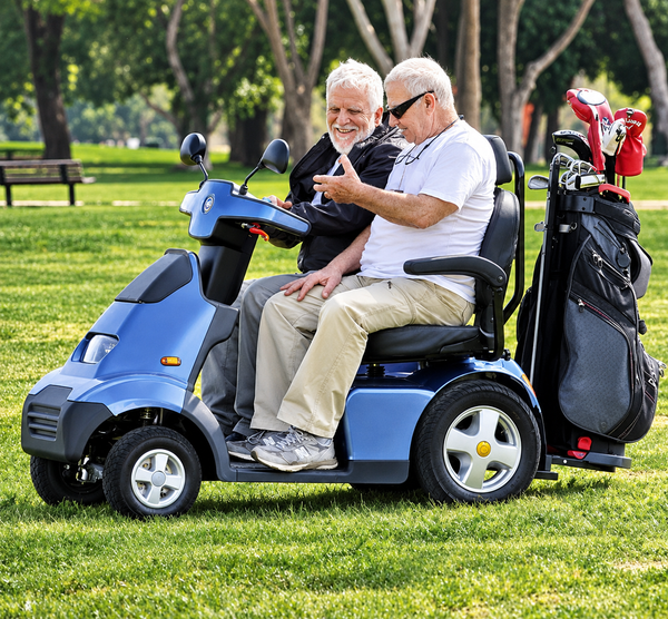 Close Up View Of The AFIKIM Afiscooter S4 Scooter In The Dual Seat Configuration With Optional Golf Club Accessory Shown In An Outdoor Setting With Two Men Conversing