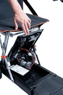 Close Up View Of The Battery Compartment For The Feather 27X Mobility Scooter Shown With A Hand Lifting The Lid