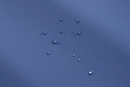 Close Up View Of The Cover Of The Wellell Domus 3 Alternating Pressure Redistribution Mattress System With Quilted Cover Shown With Water Droplets Highlighting Its Waterproof Material