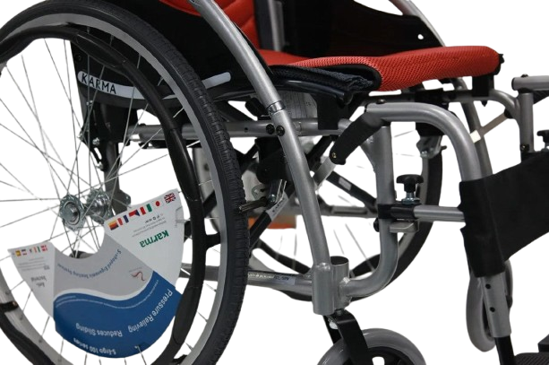 Close Up View Of The Frame And Wheels Of The Karman S-Ergo 125 Wheelchair Shown With Red Cushions And Silver Frame