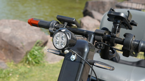 Close Up View Of The Green Transporter Cheeta Golf All-Terrain Mobility Scooter Phone Holder And Lights