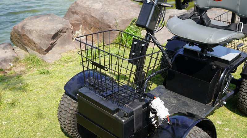 Close Up View Of The Green Transporter Cheeta Golf All-Terrain Mobility Scooter Single Seat And Front Basket In An Outdoor Park Setting