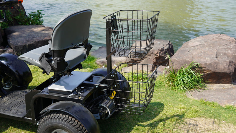 Close Up View Of The Green Transporter Cheeta Golf All-Terrain Mobility Scooter Single Seat And Rear Baskets In An Outdoor Park Setting