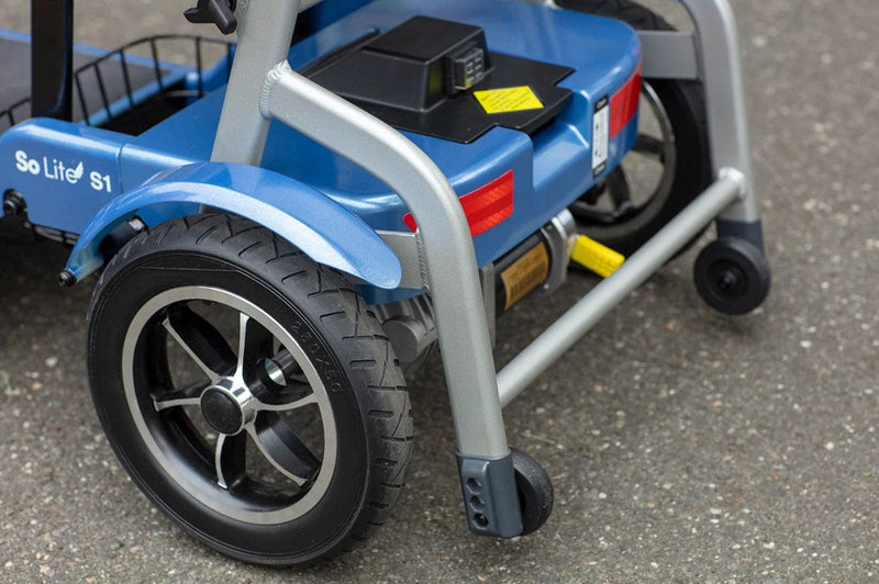 Close Up View Of The Journey So Lite Mobility Scooter Safety Wheels Shown In Blue Color
