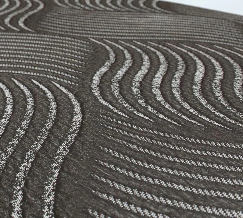 Close Up View Of The Journey UPbed Independence Rotating Adjustable Lift Bed Textured Gray And White Patterned Fabric