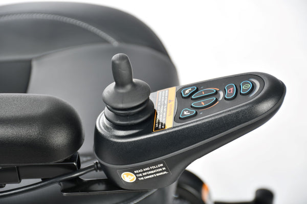 Close Up View Of The Merits Vision Sport Power Chair Control Joystick And Handlebar With Visible Buttons On A Blurred Background. 