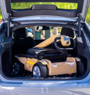 Close Up View Of The Reyhee Flex Electric Folding Mobility Scooter With A Tan Frame Shown Folded Inside The Trunk Of A Compact Car