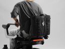 Close Up View Of The STRUTT ev1 Smart Electric Mobility Vehicle Optional Rear Storage Bag Accessory Attached To The Back Of The STRUTT ev1 With A Person Sitting In The Seat