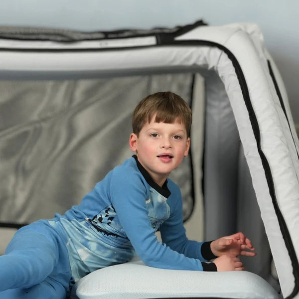 Close Up View Of The Safe Place Bedding Model 100 Safe Place Travel Bed Shown In The Gray Color With Child Inside The Structure