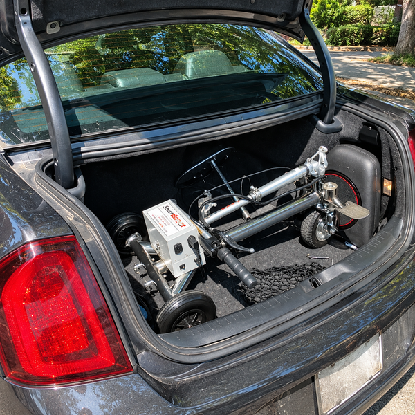 Close Up View Of The SmartScoot Lightweight Travel Mobility Scooter Shown Folded Inside The Trunk Of A Compact Car