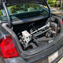 Close Up View Of The SmartScoot Lightweight Travel Mobility Scooter Shown Folded Inside The Trunk Of A Compact Car