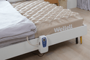 Close Up View Of The Wellell Domus 1 Alternating Pressure Redistribution Mattress Shown On A Platform Bed Frame With The Control Unit Hanging Off The Side Of The Bed Frame In A Home Care Setting