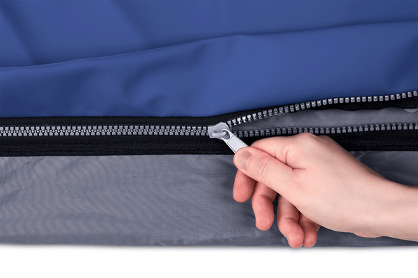 Close Up View Of The Zipper Of The Wellell Domus 3 Alternating Pressure Redistribution Mattress System With Quilted Cover Shown With A Hand Operating The Zipper