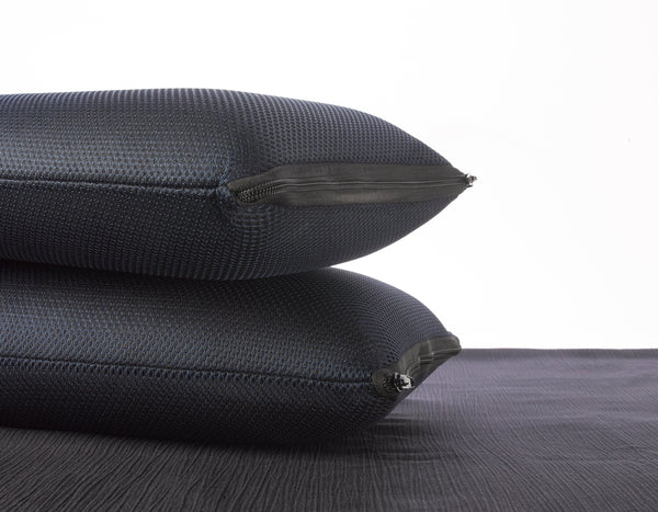Close Up View Of Two Of The Eurolux Memory Restore Travel Pillows Stacked On Each Other Shown With A White Background