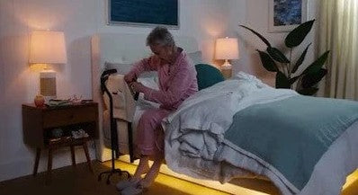 Dawn House Smart Bed Side View Elderly Woman Using Side Rail With Underbed Lighting